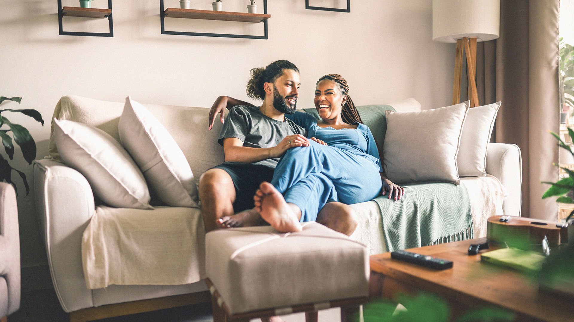 Couple relaxing on the couch smiling 