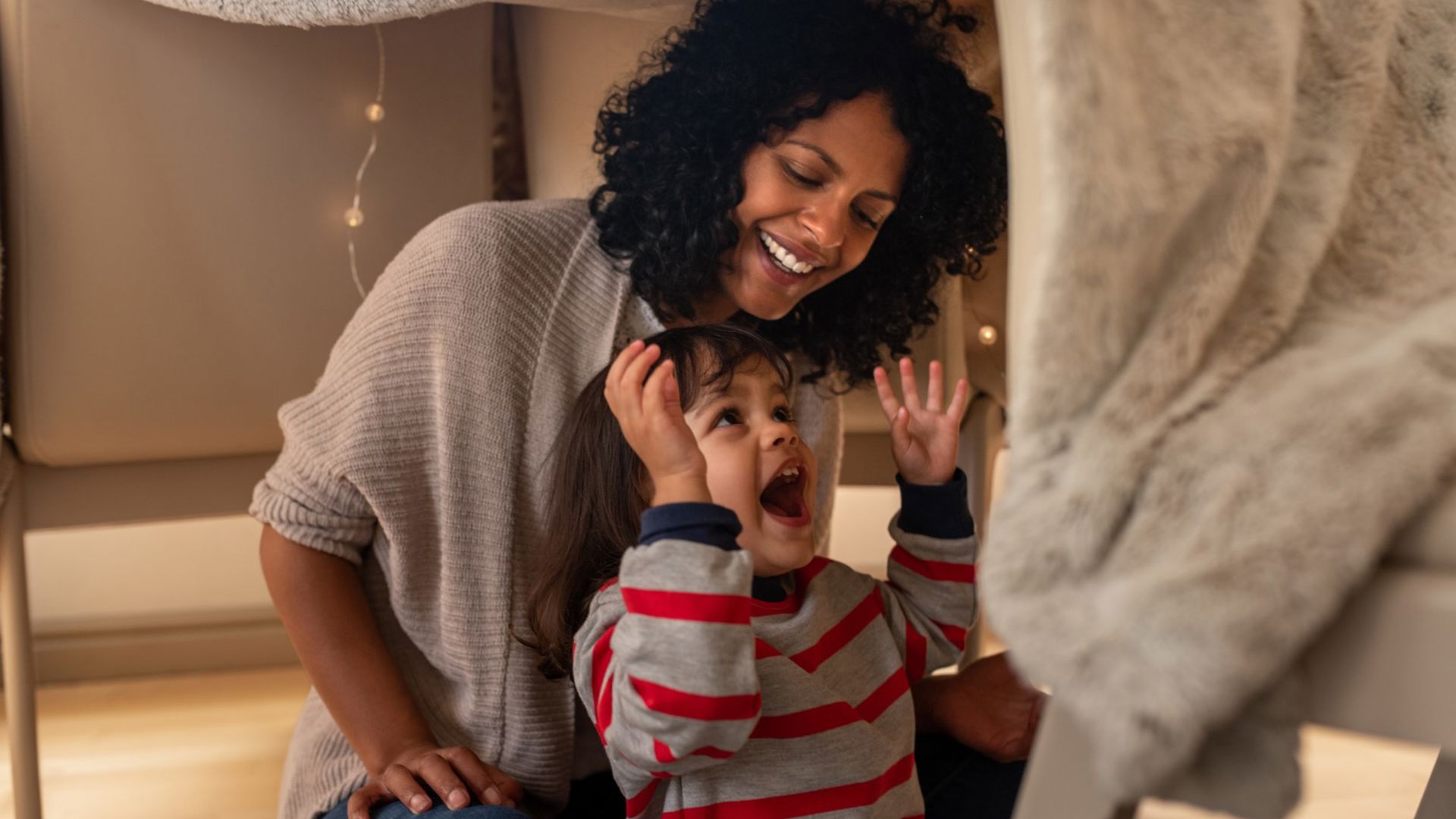 Mother and daughter playing hide and seek