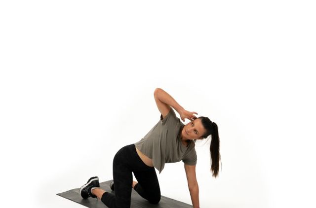 Lady stretching after watching stretching videos supporting GMHBA members