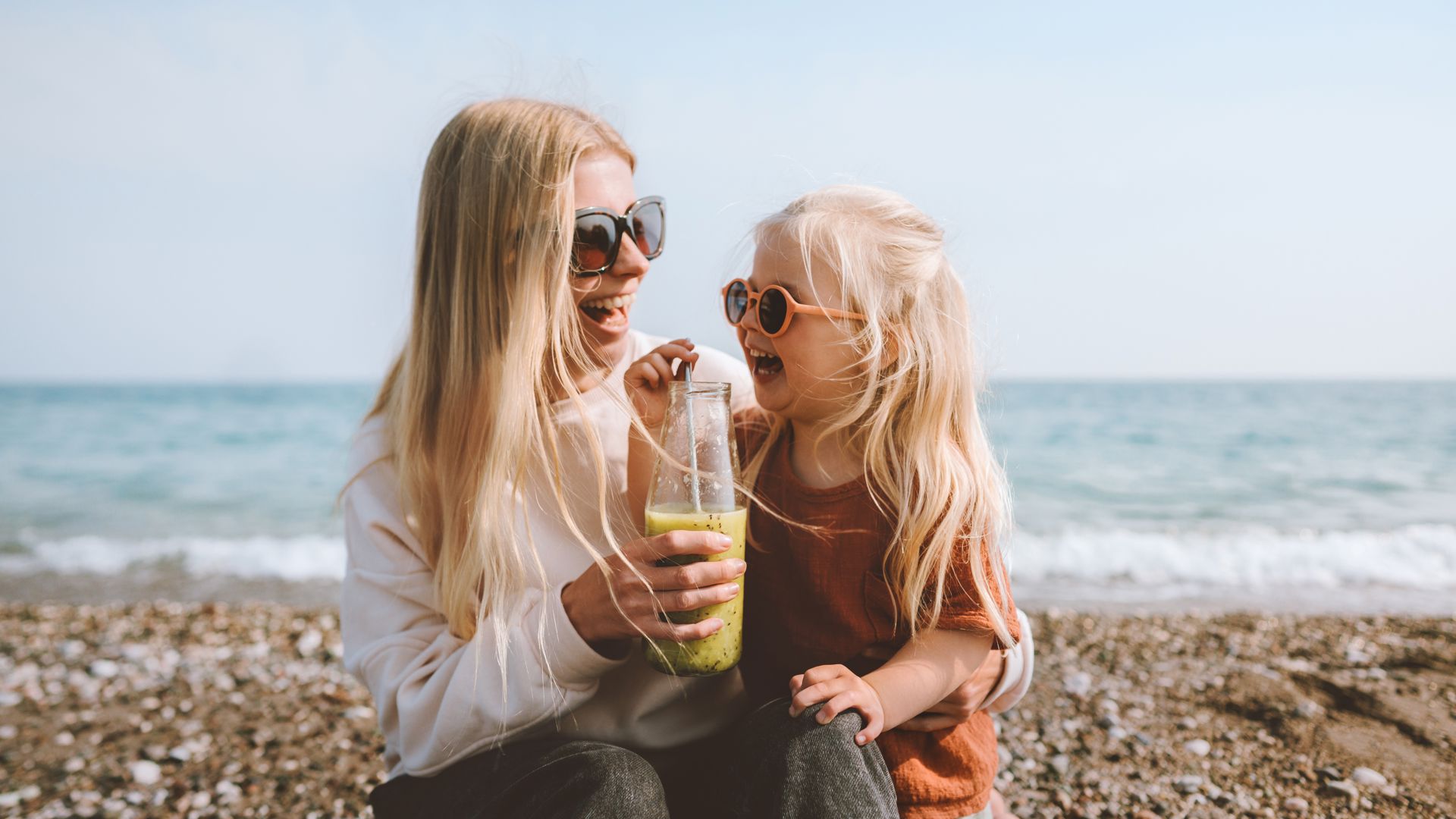 Woman and daughter wearing sunglasses
