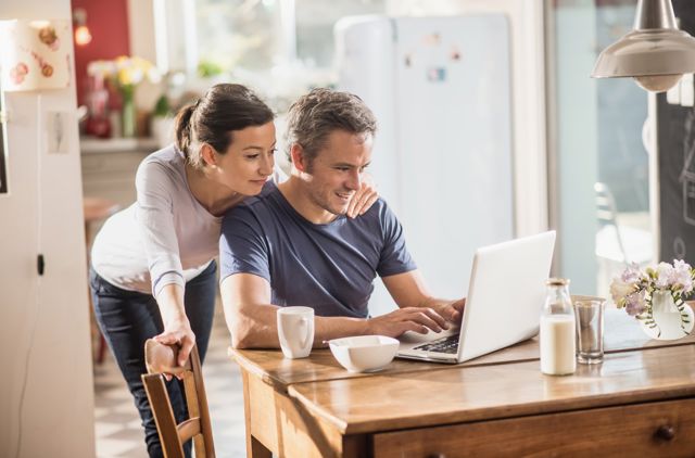 Couple completing gmhba rebate form at their kitchen table