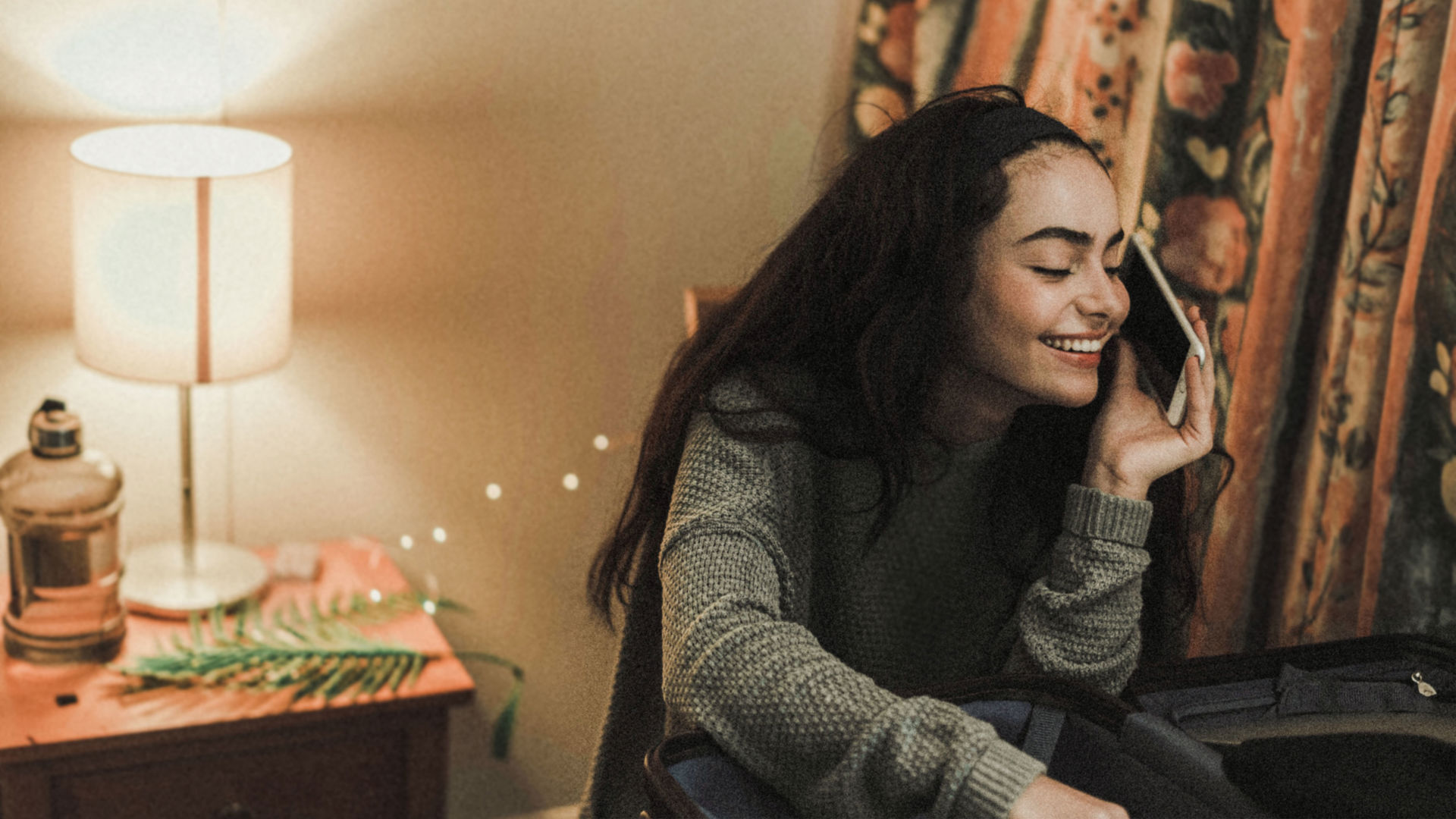 Young girl talking on het phone in a dark room