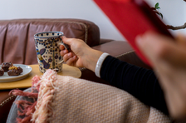 On the couch with a sweet treat and a blanket