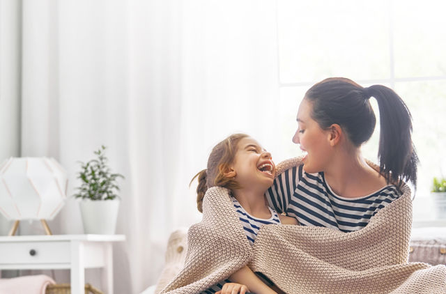 Woman wrapped up with child in blanket