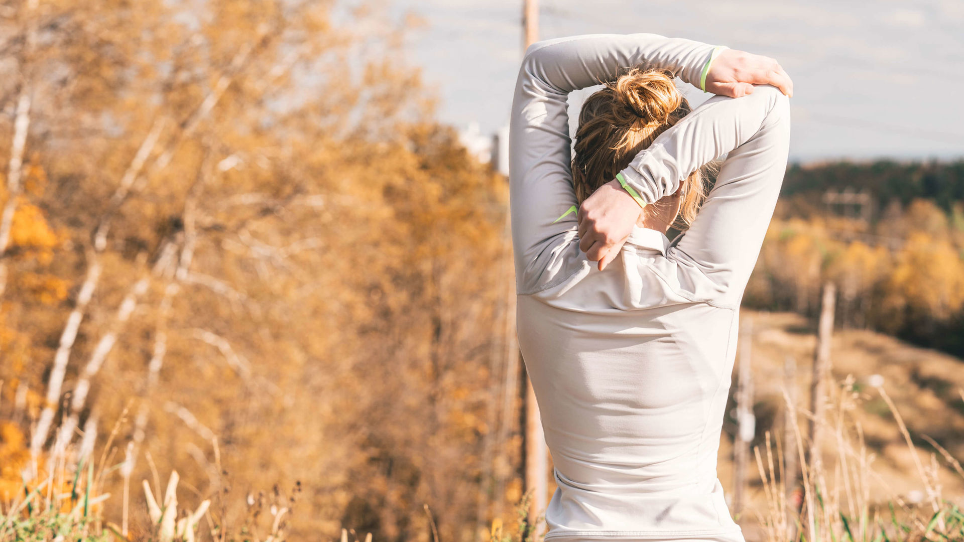 Woman stretching her back in field