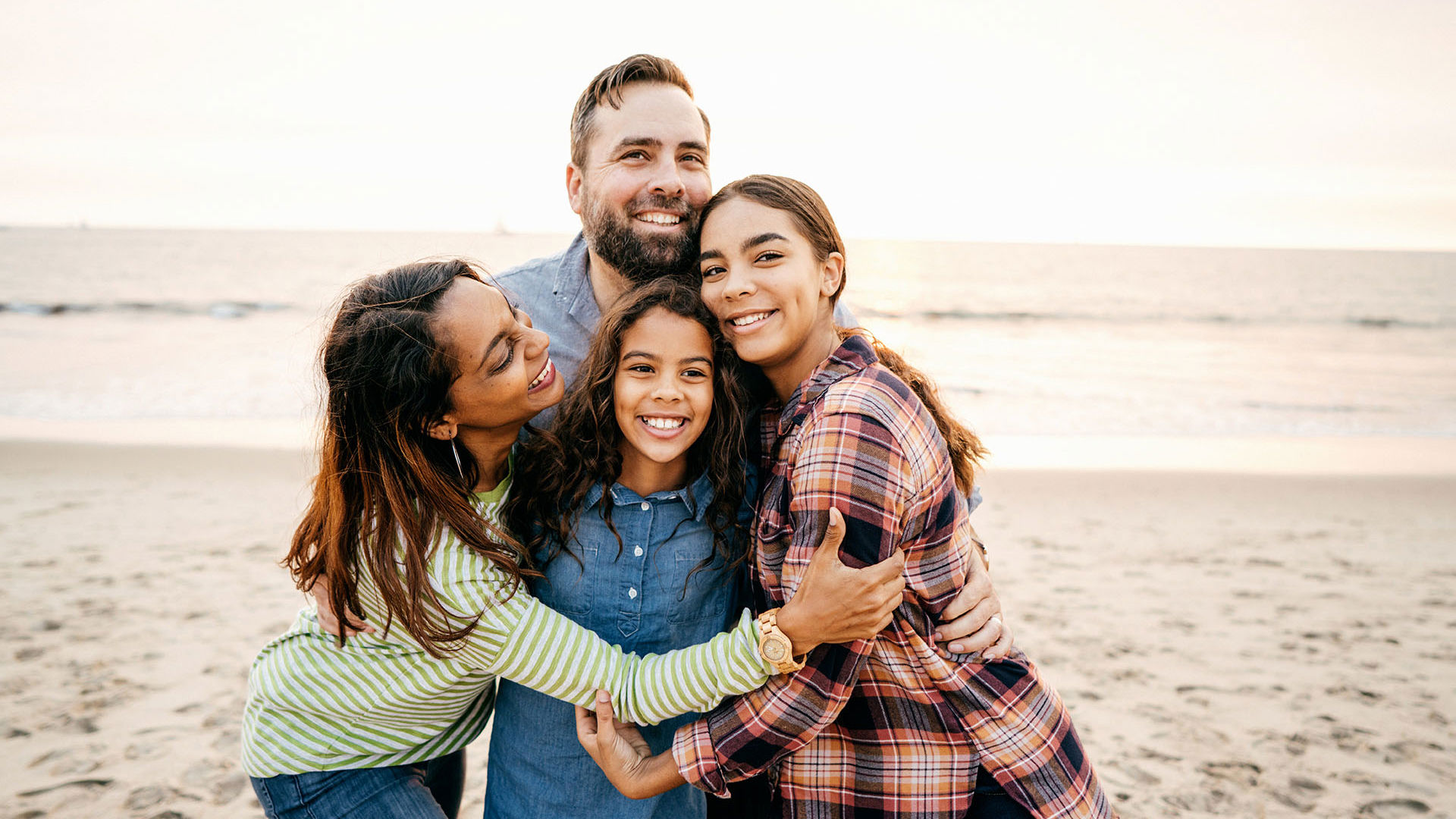 Happy family enjoying a summer night on the beach