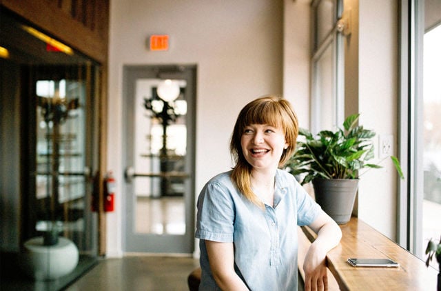 All Abilities woman sitting in cafe looking out the window
