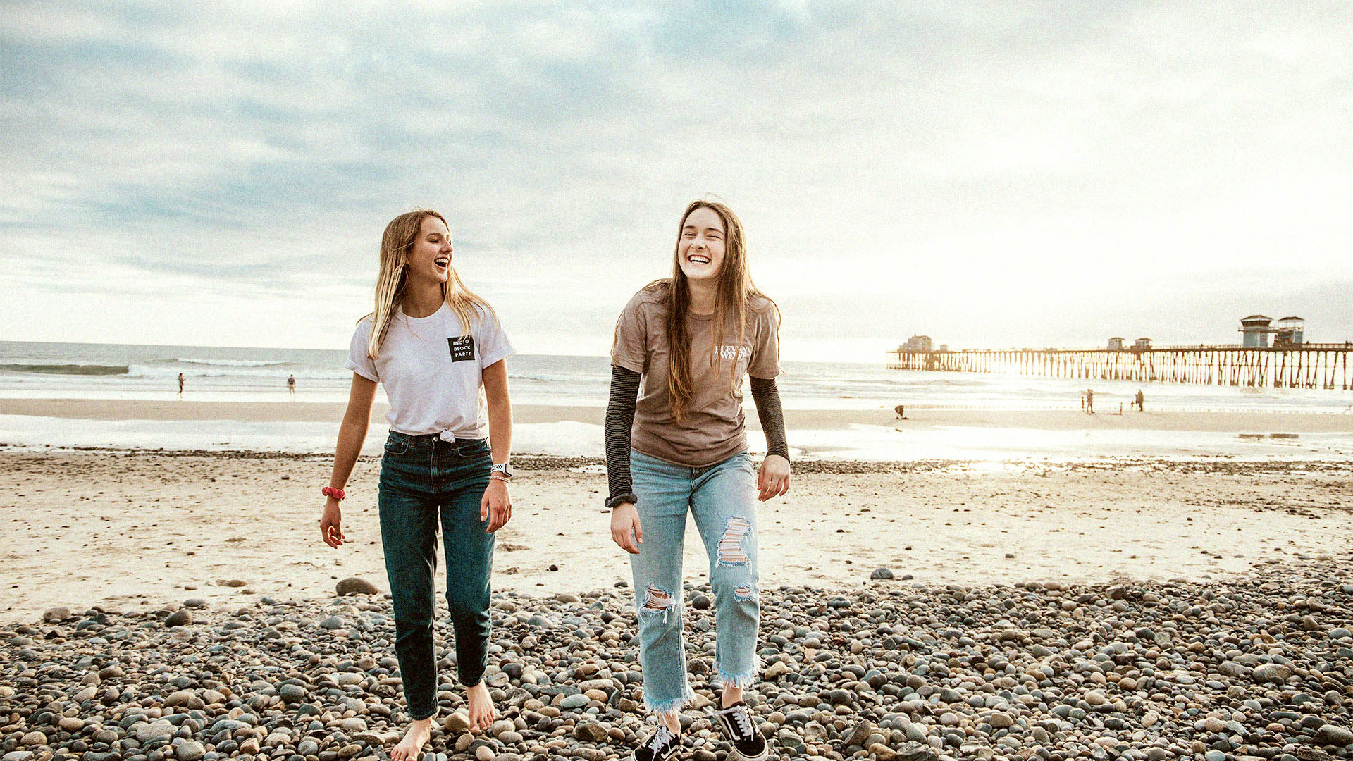 Young Females on beach new to health Insurance
